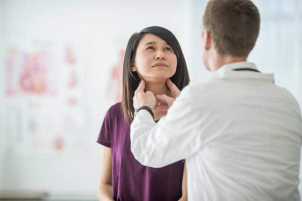 doctor checking for thyroid problems