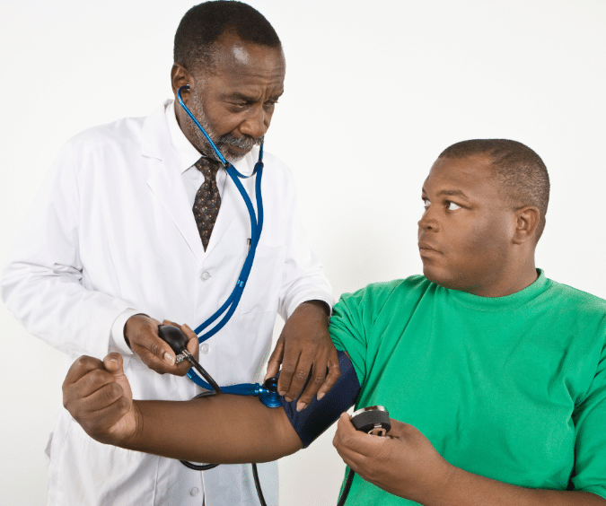 Doctor getting the patient's blood pressure 