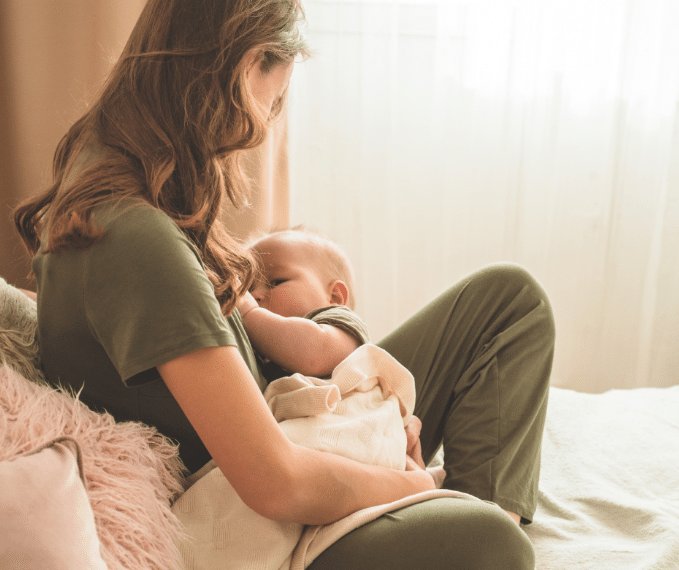 A woman breast feeding a baby