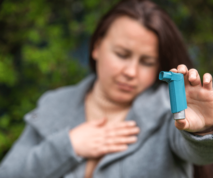 Woman holding an inhaler 