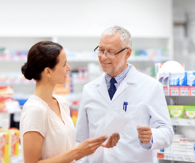 Pharmacist talking to a customer 