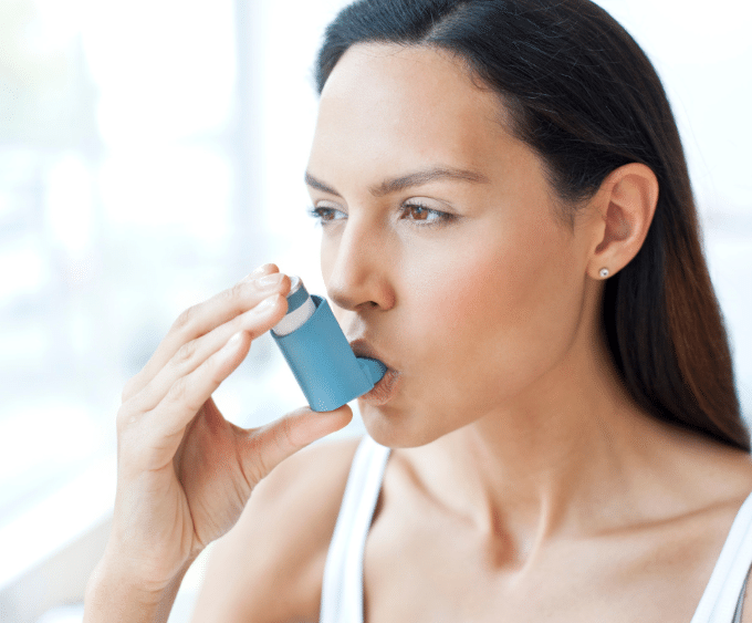 Woman using inhaler 