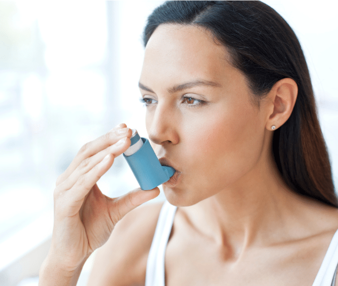 Woman using an inhaler 