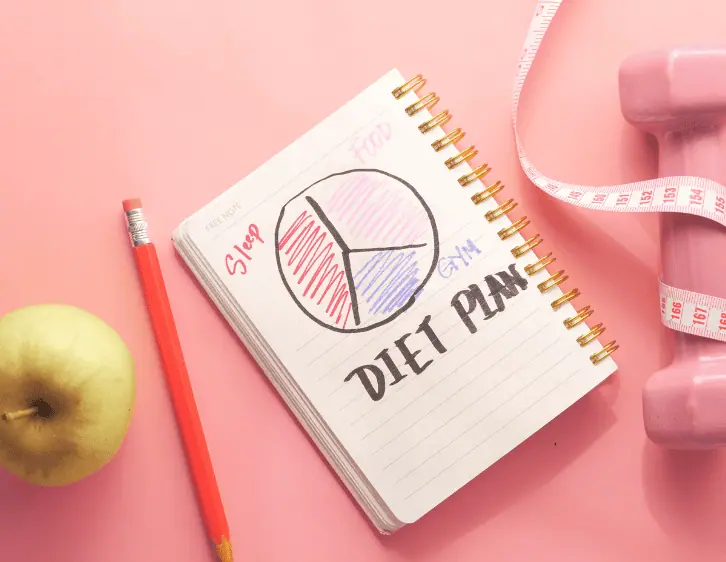 apple with notebook and pencil for diet plan