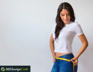 a girl is measuring her waist for weight loss
